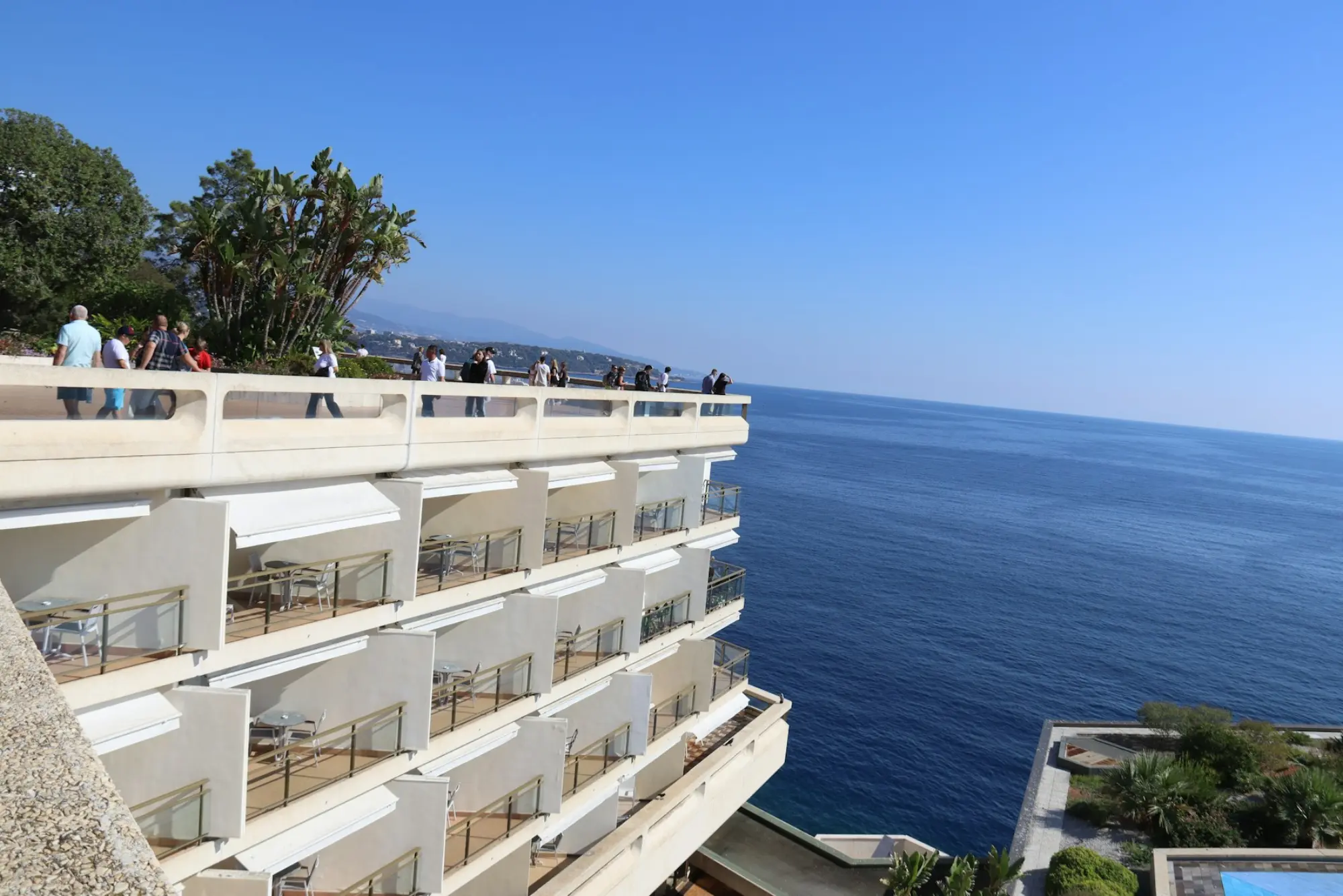 Terraced white hotel balconies above a deep blue sea